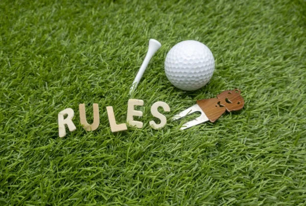 Rules of golf word is on green gras with golf ball and marker