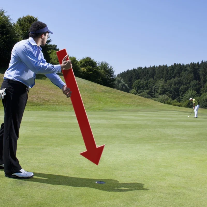 Caddy pointing at a hole on golf course