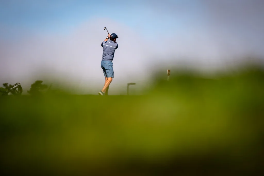 Golfer mid-swing during practice, working towards new goals for the 2026 golf season.