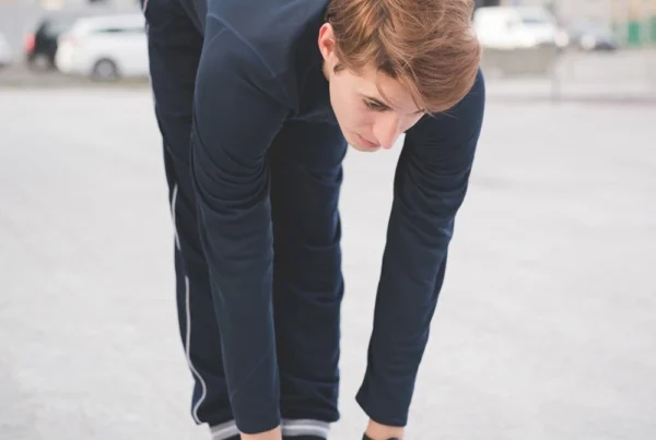 Young golfer stretching and warming up before a round of golf.